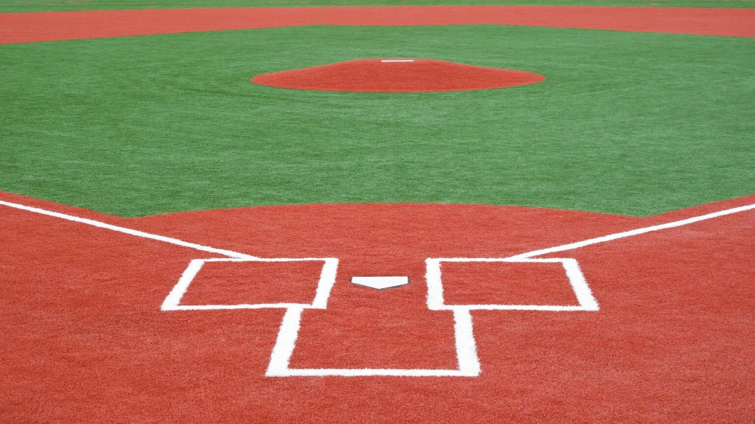 From home plate, enjoy the view of the Deer Valley baseball field with its striking red and green artificial grass. The pitcher's mound, batter's boxes, and home plate are complemented by pristine white lines outlining this beautifully crafted installation.